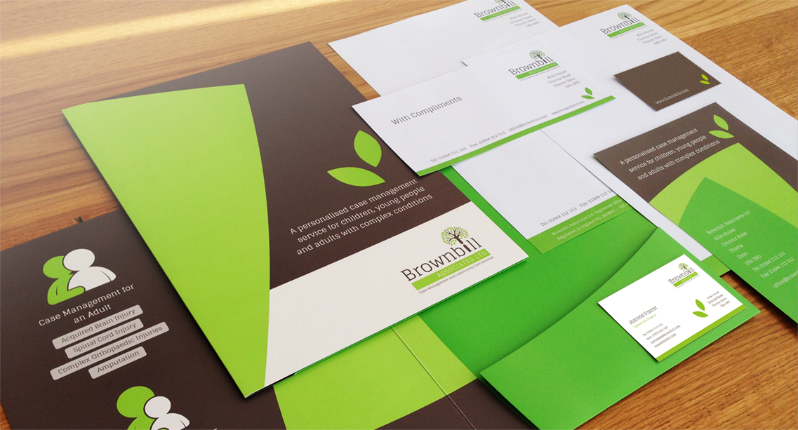 Green and brown branded stationery for Brownbill Associates Ltd., including business cards, folders, and letterheads on a wooden table.
